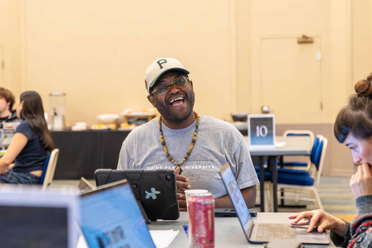 Shepherd Fourgson laughs as he works with his peers.