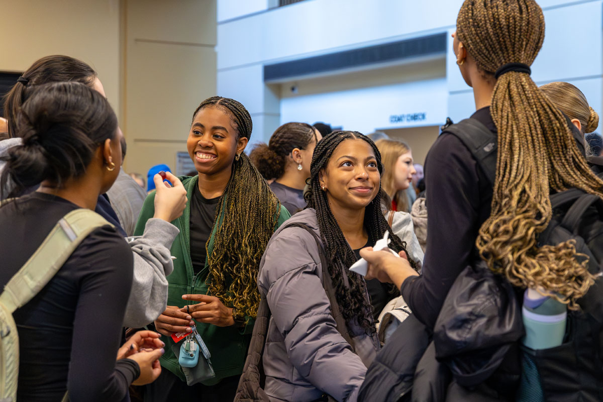 Students visit in the Playhouse lobby.
