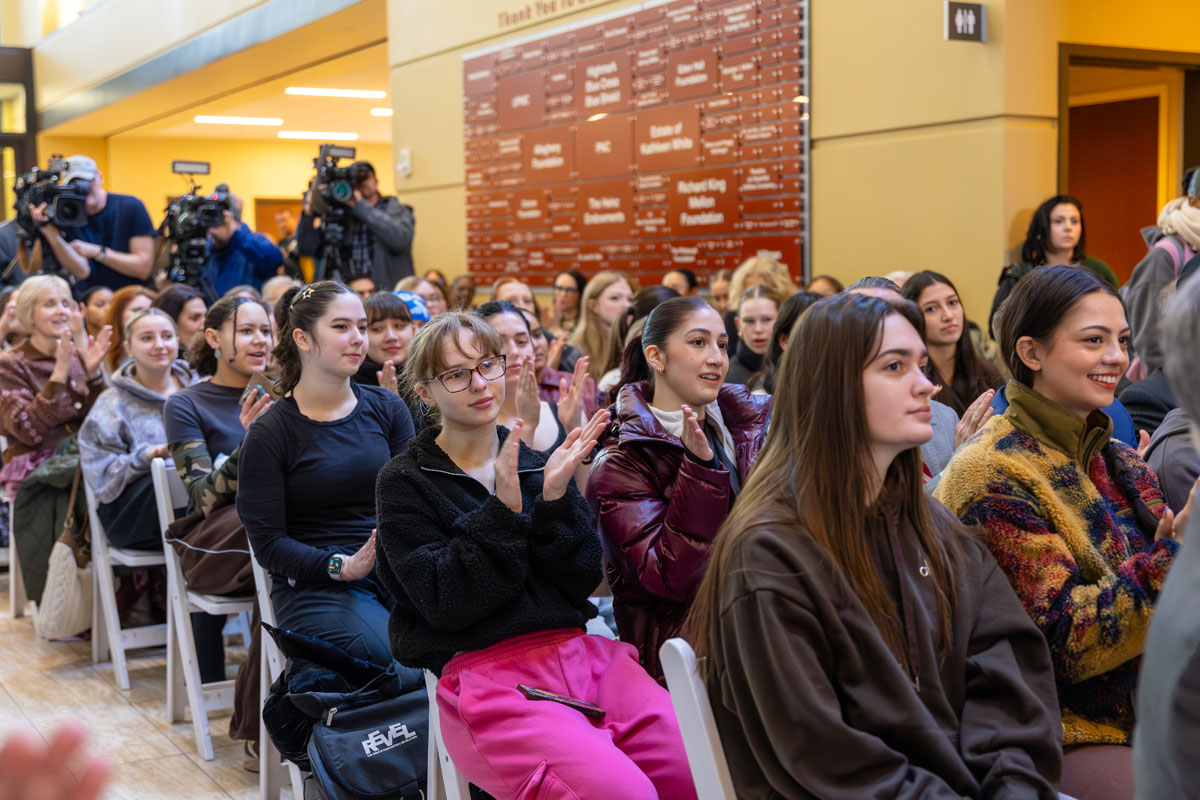 A crowd of people sit in chairs in the Pittsburgh Playhouse Lobby.