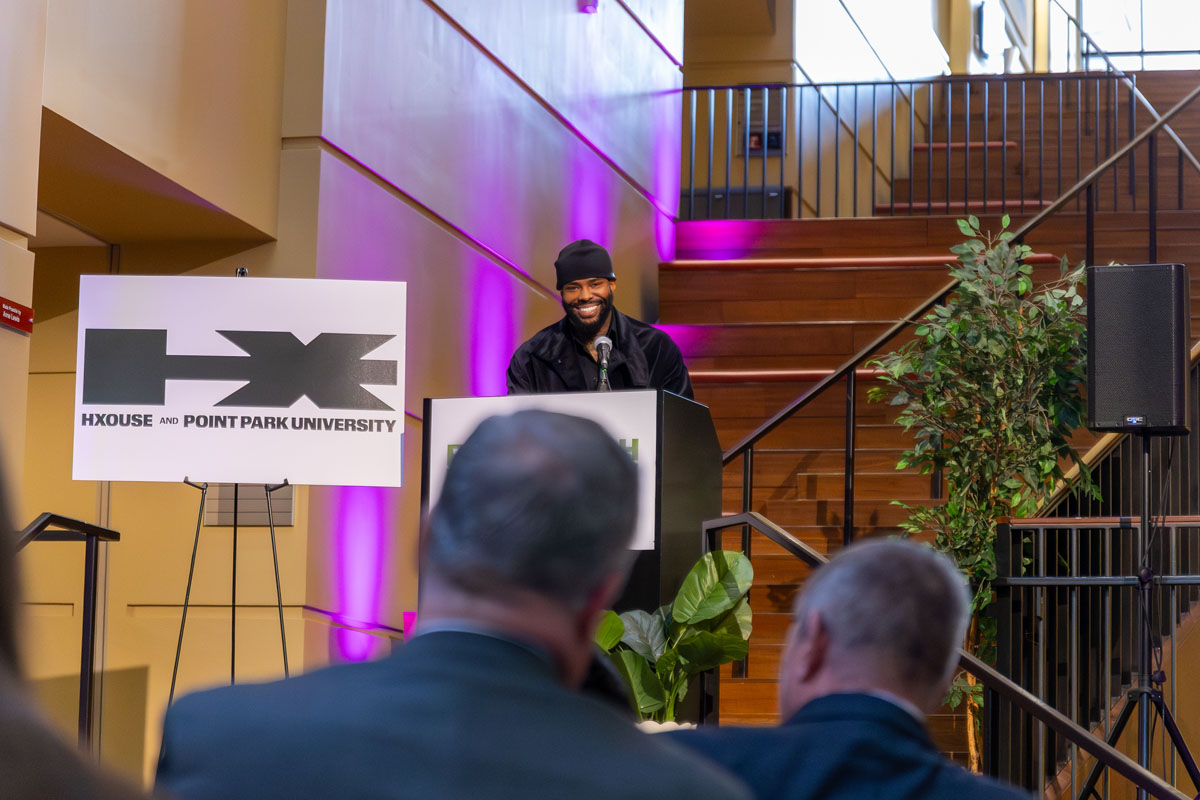 La Mar Taylor addresses a crowd from a podium.