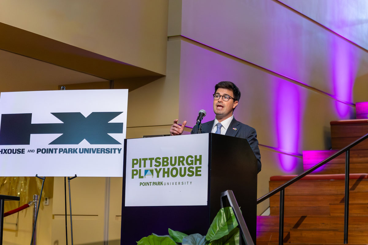 Mayor Corey O'Connor addresses a crowd from behind a podium. 