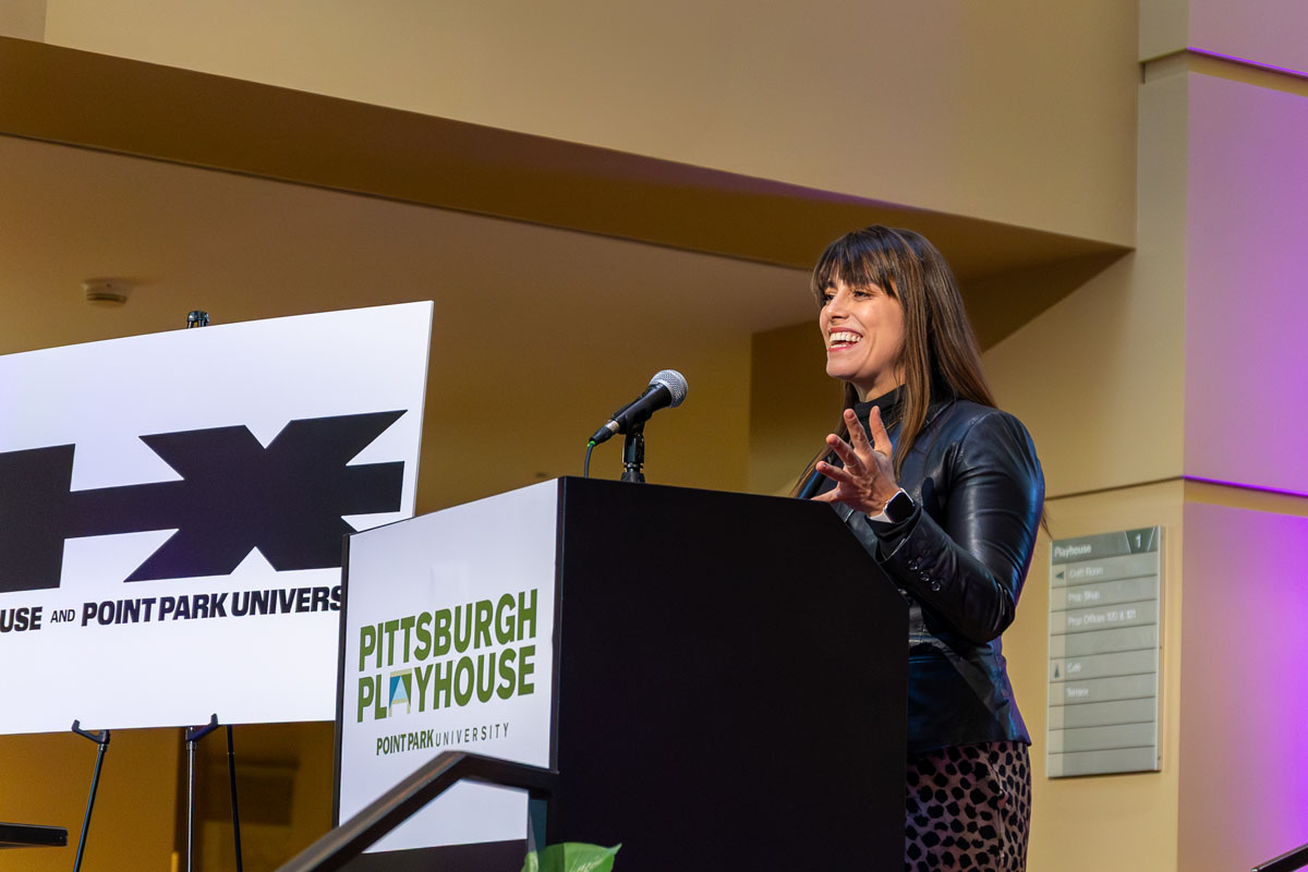 County Executive Sara Innamorato addresses a crowd from behind a podium.