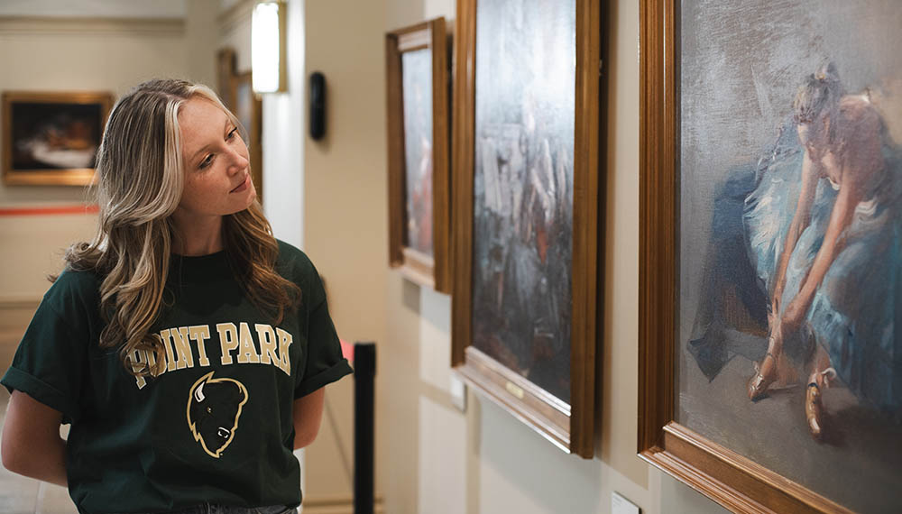 A student in the GRW art gallery in Lawrence Hall. 