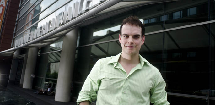 Jordan Grubb, a 2008 musical theatre alum, stands outside the Alvin Ailey American Dance Theater in New York City. | Photo by Chris Rolinson