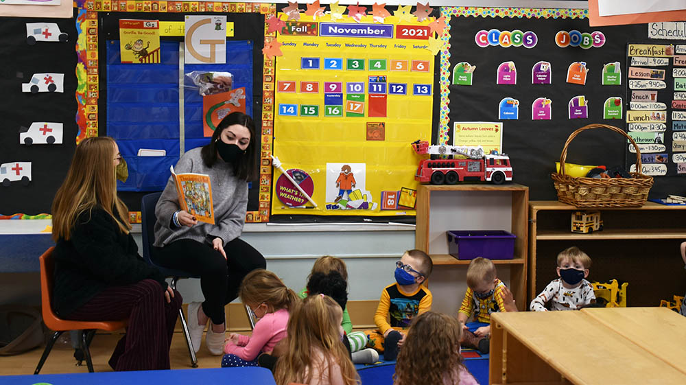 Point Park University students read a story to children at Wee Care Children's Center in Heidelberg, Pa.