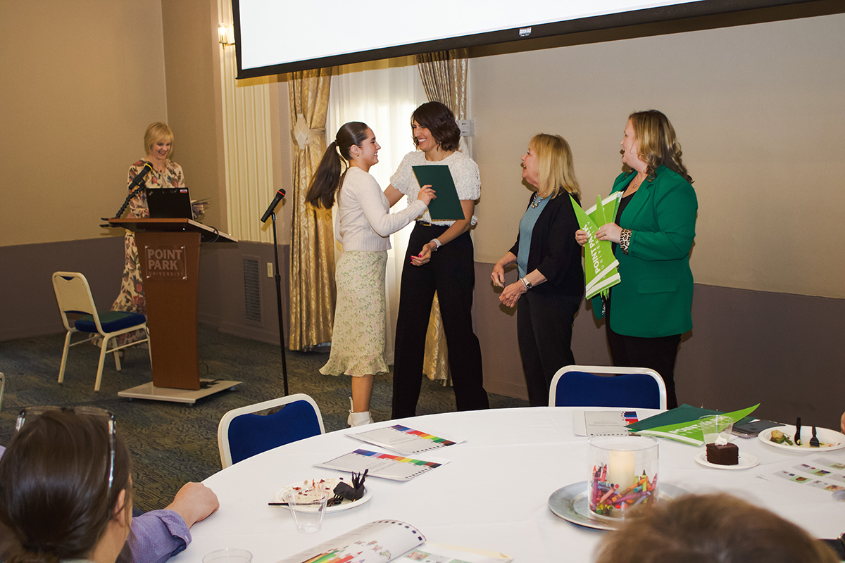 Jordan O'Malley receives her student teaching certificate from Kamryn York, Ed.D., at the Celebration of Student Teaching. Photo by Nadia Jones.