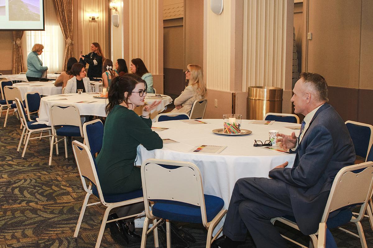 Graduate student Kathryn Mulvey speaks with adjunct faculty Charles Youngs, Ed.D., at the Celebration of Student Teaching. Photo by Nadia Jones.