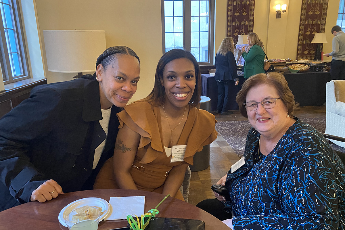 Shavonne M. Johnson, center, and family pose for a photo with Karen McIntyre, Ph.D. Photo by Nadia Jones.