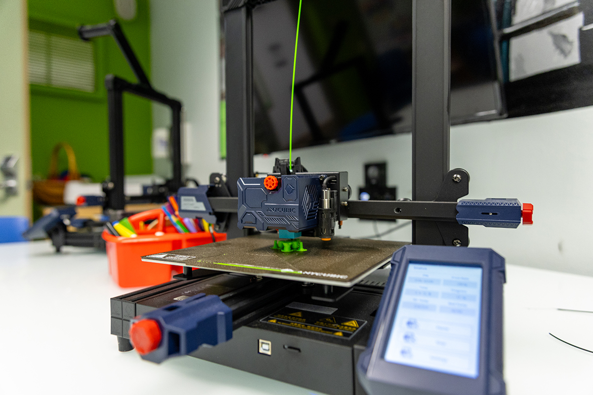 A game piece is printed on a 3-D printer.