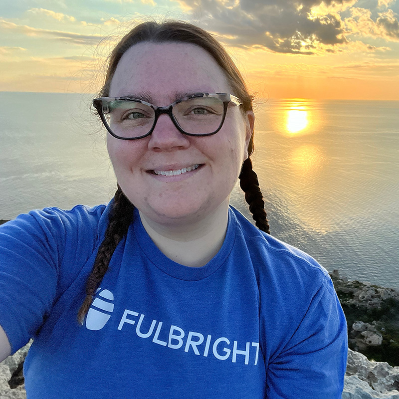 Pictured is Cailtin Dee in front of a sunset in Malta. Submitted photo.