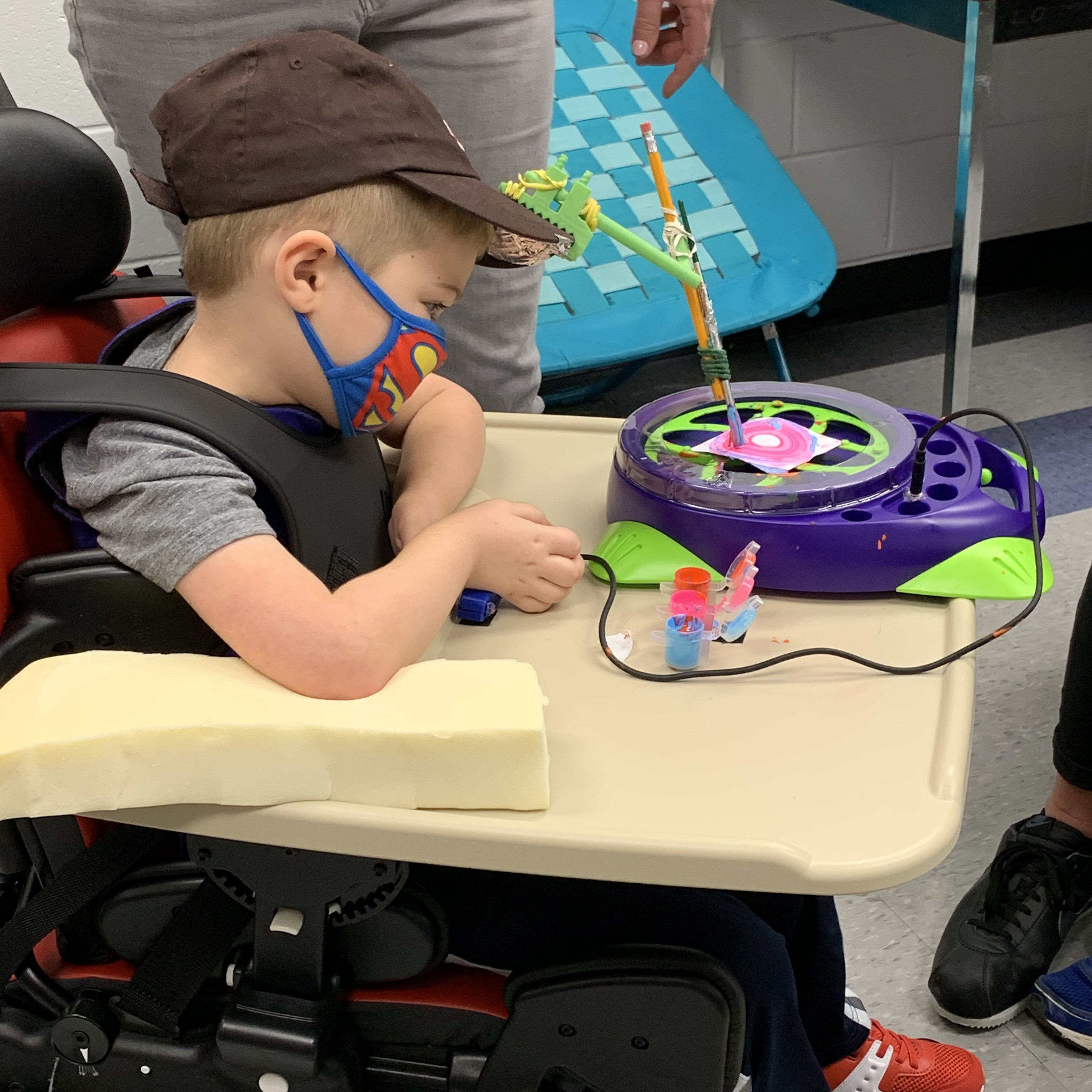 Pictured is kindergarten student Sam using one of Carly Lutz' adaptive devices.