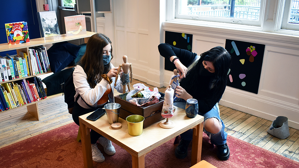 Pictured are two students making puppets at the Children's Museum of Pittsburgh. Photo by Nicole Chynoweth.