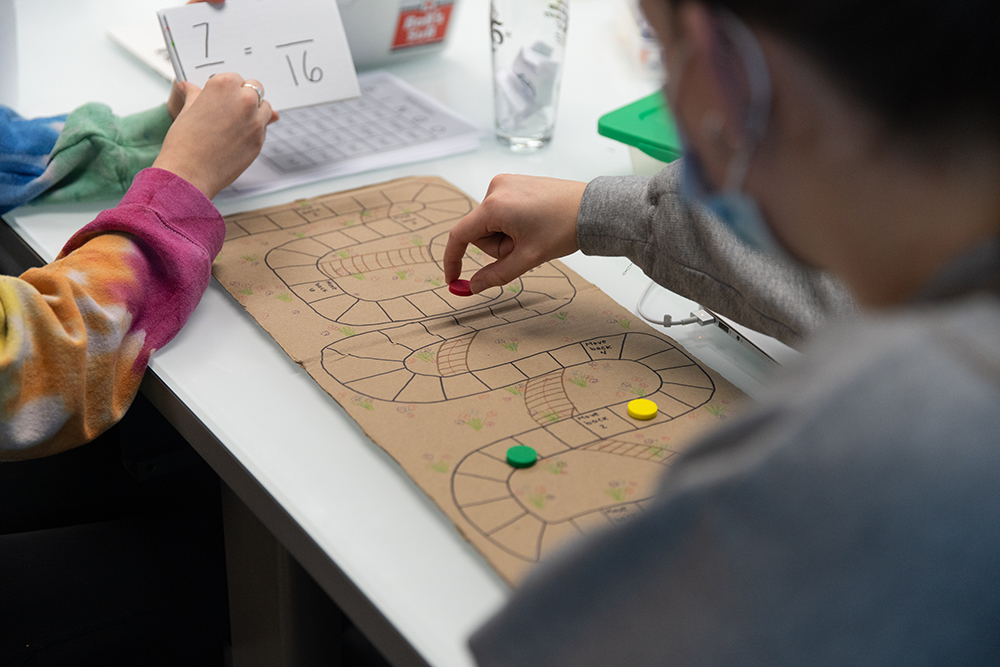 Students try out a math board game created in Matt’s Maker Space Lab. Photo by Randall Coleman.