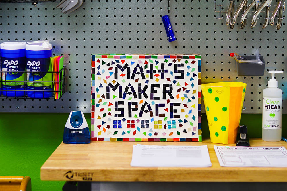Pictured is a mosaic with the words "Matt's Maker Space" on it, in front of a supplies wall in Point Park's Matt's Maker Space Lab. Photo by Natalie Caine.