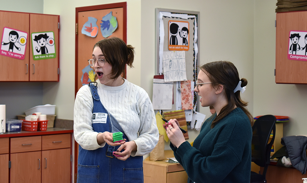 Pictured are Chloe Troutman and Bethani Rechtorik teaching a lesson at Foster Elementary School. Photo by Nicole Chynoweth.