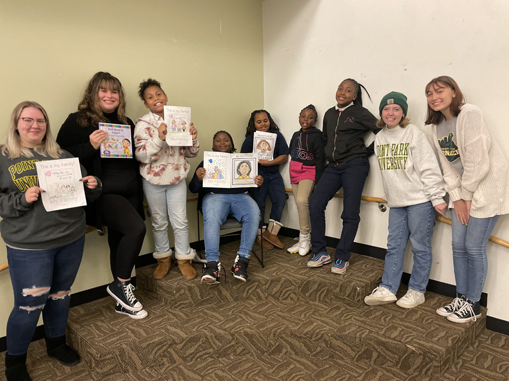 Point Park University students pose for a photo with students at Pittsburgh Faison after facilitating a mini-lesson. The field experience was part of Point Park's Family and Community Diversity course. Submitted photo.