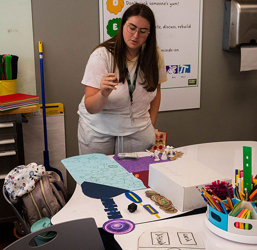A high school student describes her board game.