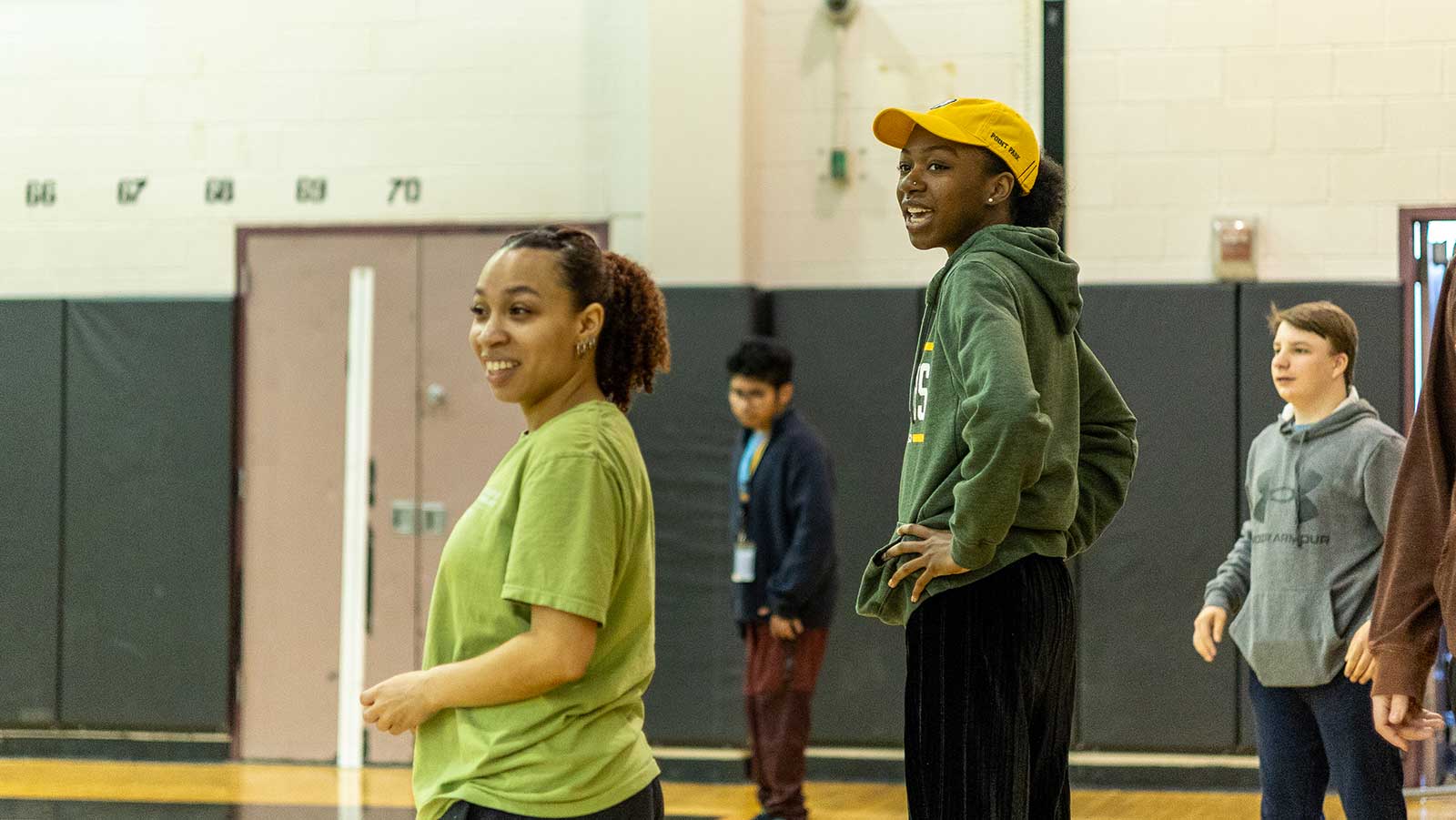 Two Point Park students stand in a gym with students from Brashear High School.