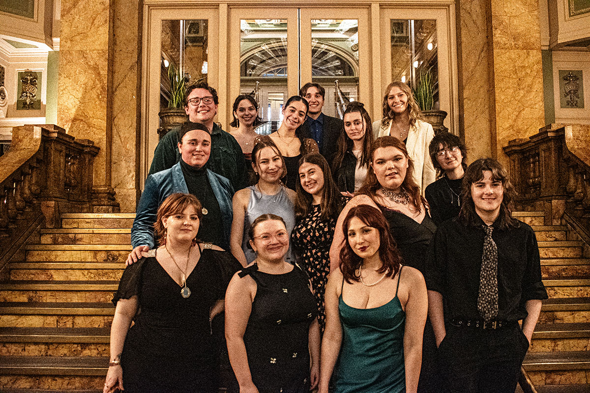Students pose on the stairs at the Grand Concourse.