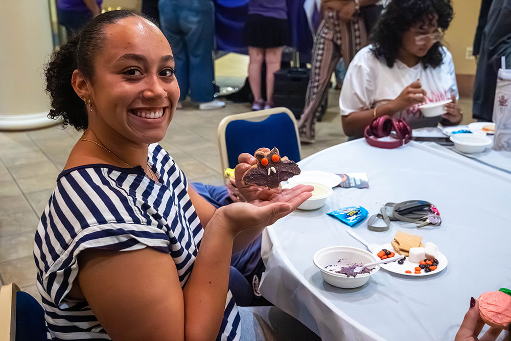 A student poses with a cookie they decorated.