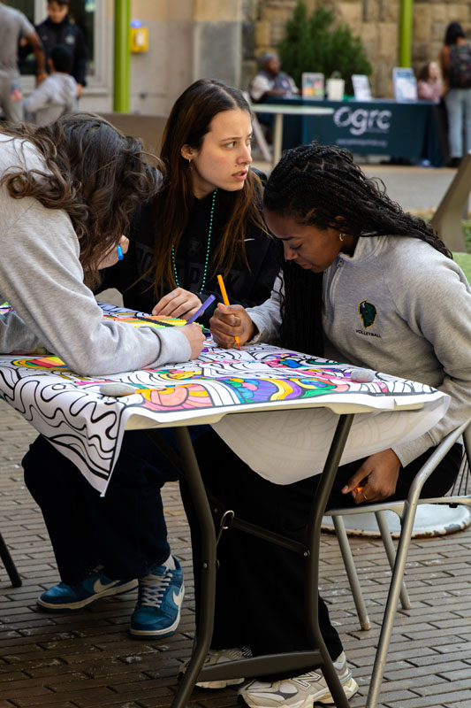 Students color a banner.
