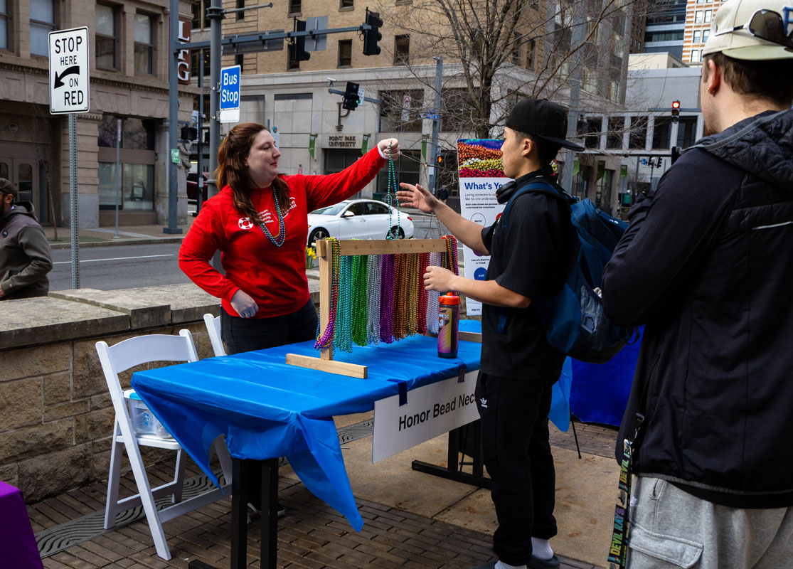 Students select beads to wear for the walk.