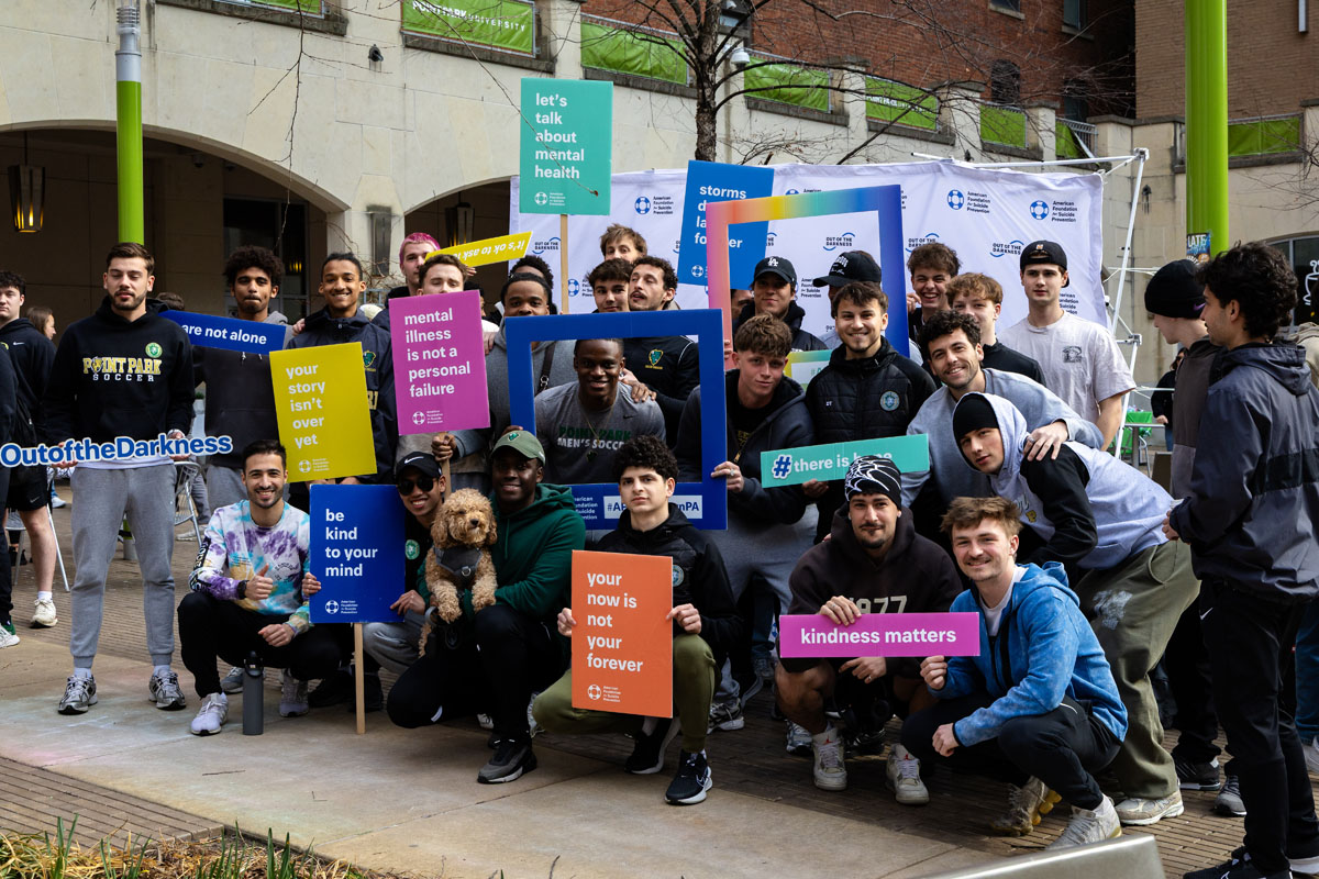 Students pose with suicide-prevention signs.