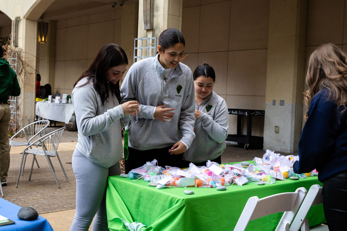 Students select giveaways from a table.