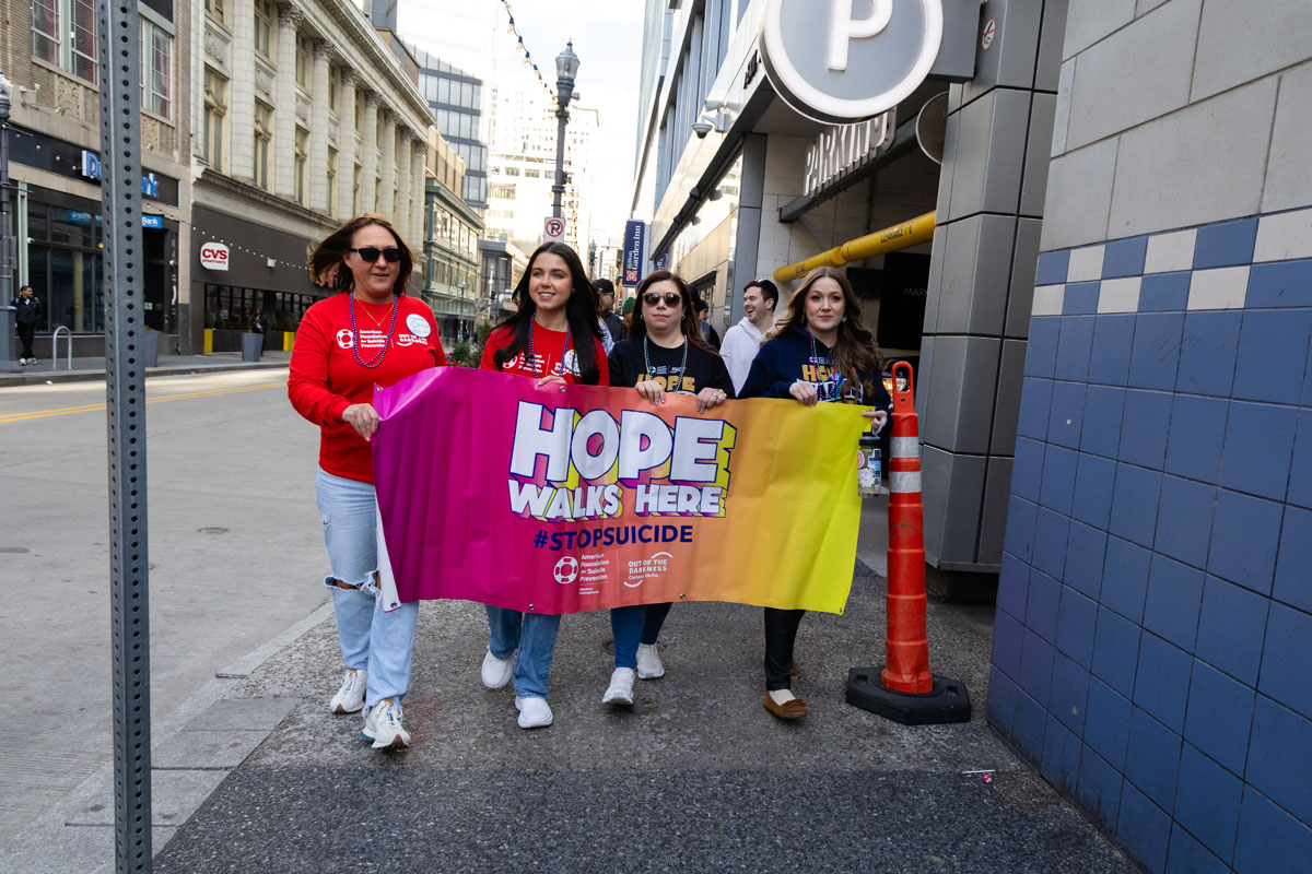 Leaders hold the Hope Walks Here sign.