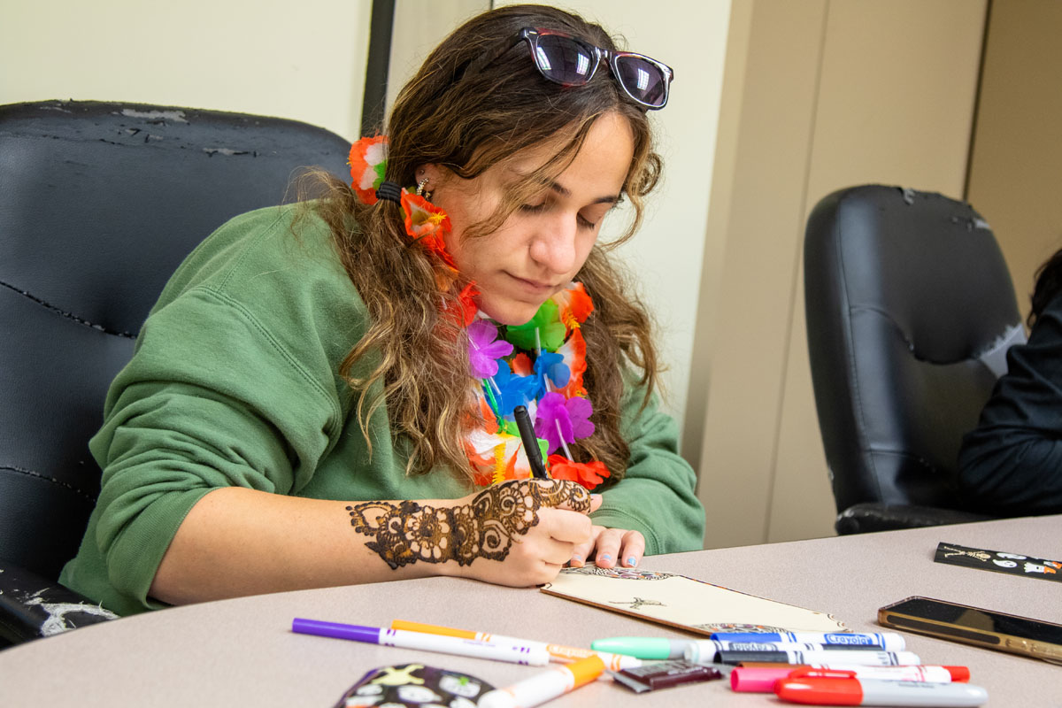 A student colors at a table.