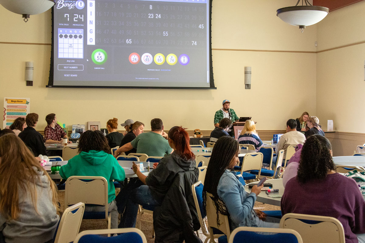 A room full of students and staff play bingo.