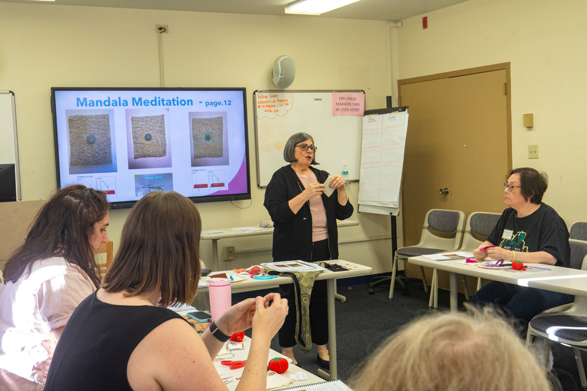 Dr. Vincenne Revilla Beltran teaches a stitching class.