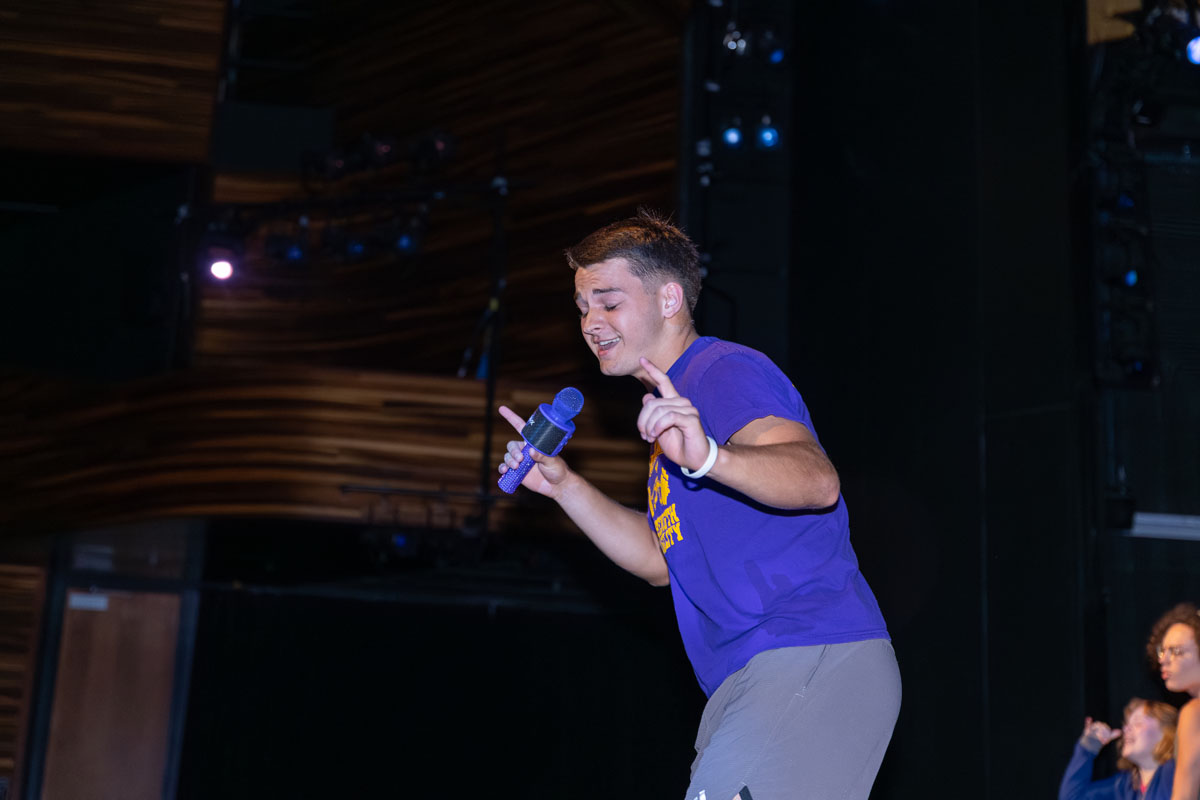 A Student performs a lip sync on the stage. 