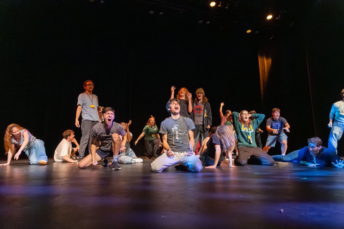 Students perform a lip sync on the stage. 
