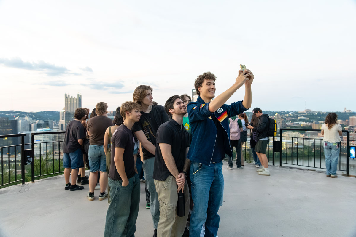 Students take selfies from a lookout on Mt. Washington.