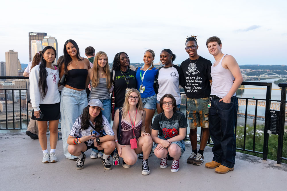 A group of students on a lookout with Pittsburgh in the background.