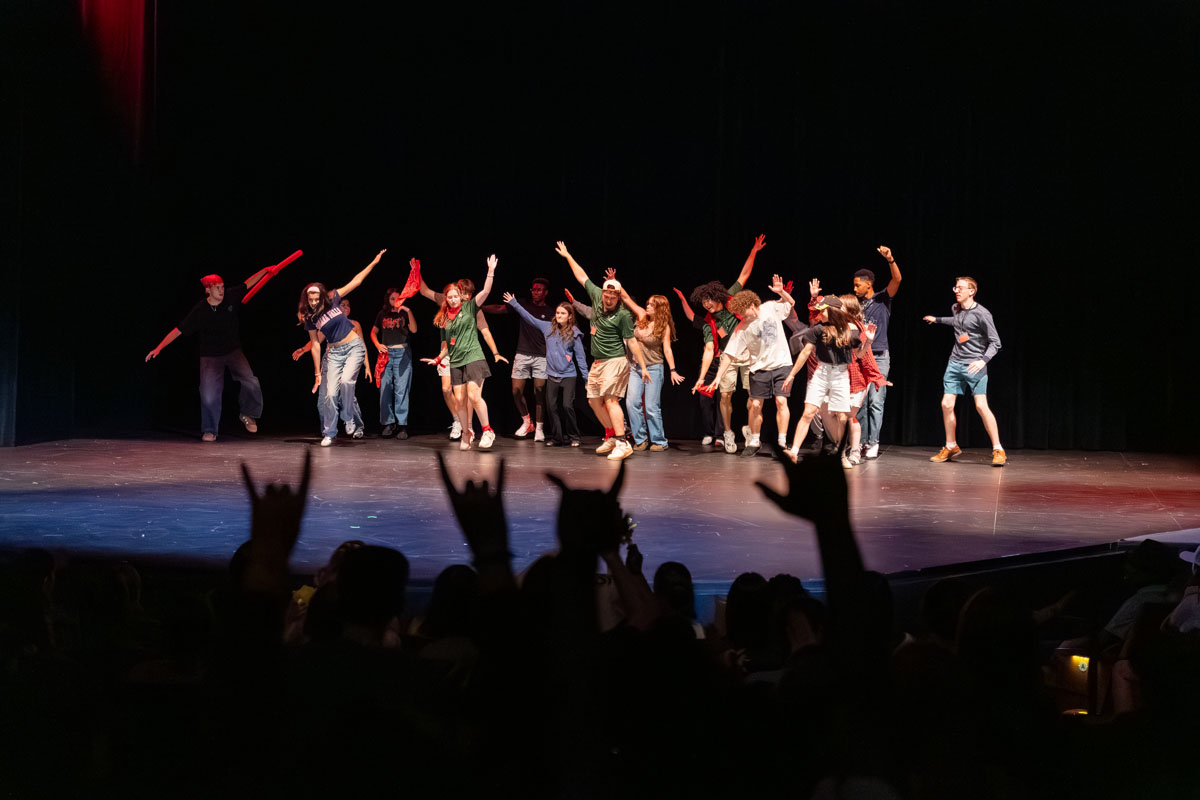 A group of students performs in the lip sync battle on stage.