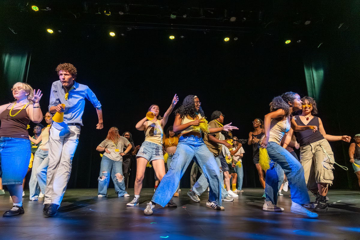 A group of students performs in the lip sync battle on stage.