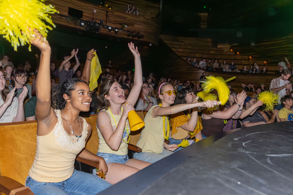 Students in the first row cheer at the lip sync battle.
