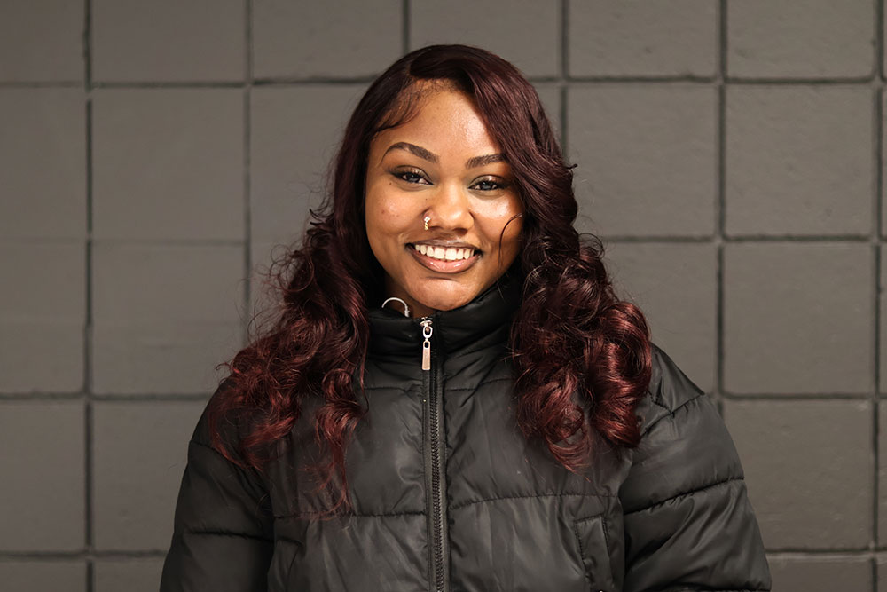 A young Black woman smiles.