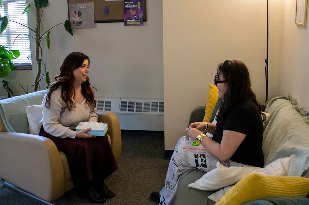 Cassie Moffat, the director of the UCC, talks with a student in her office. Photo by Evelyn Poulianov.