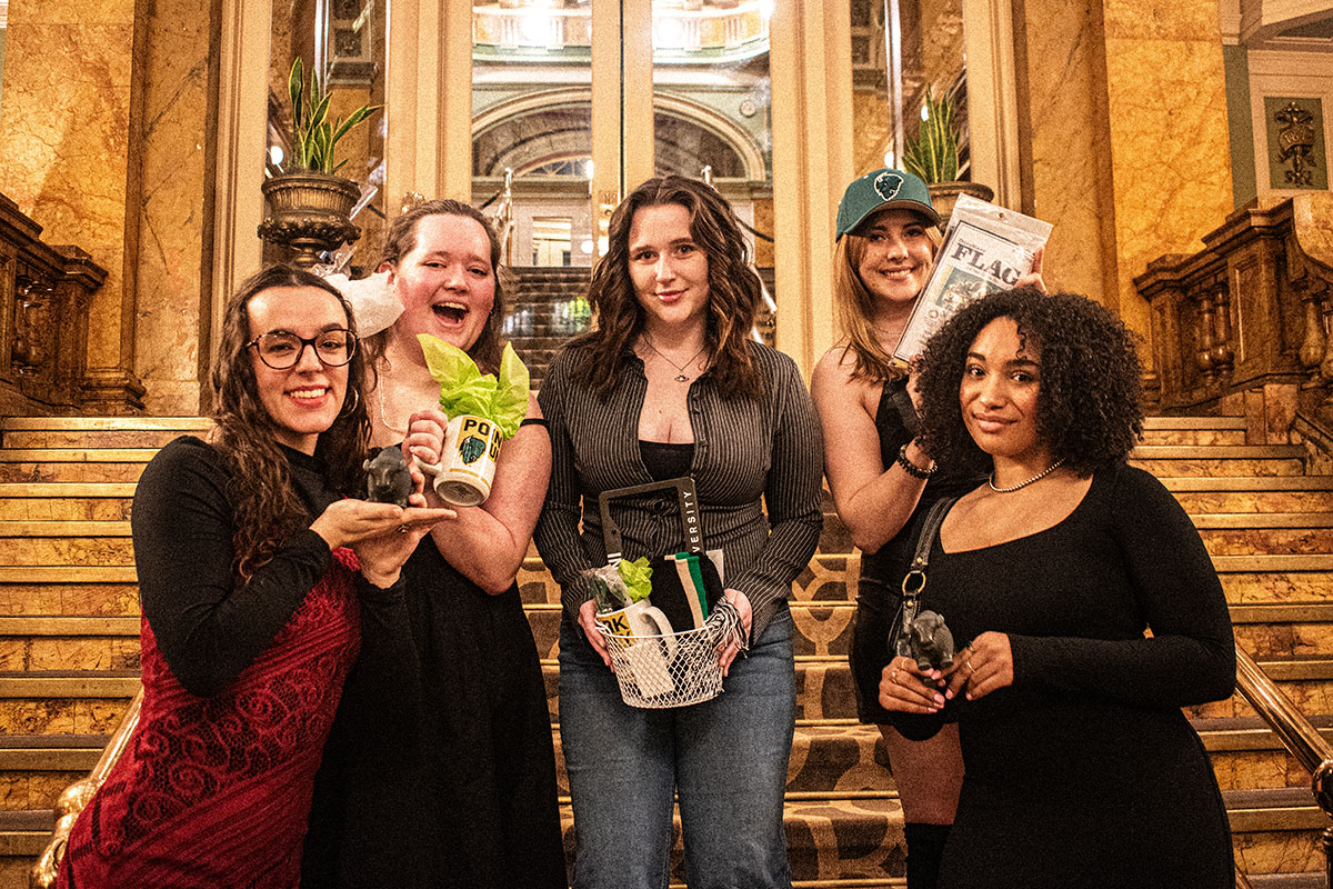 Seniors pose on the stairs of the Grand Concourse.