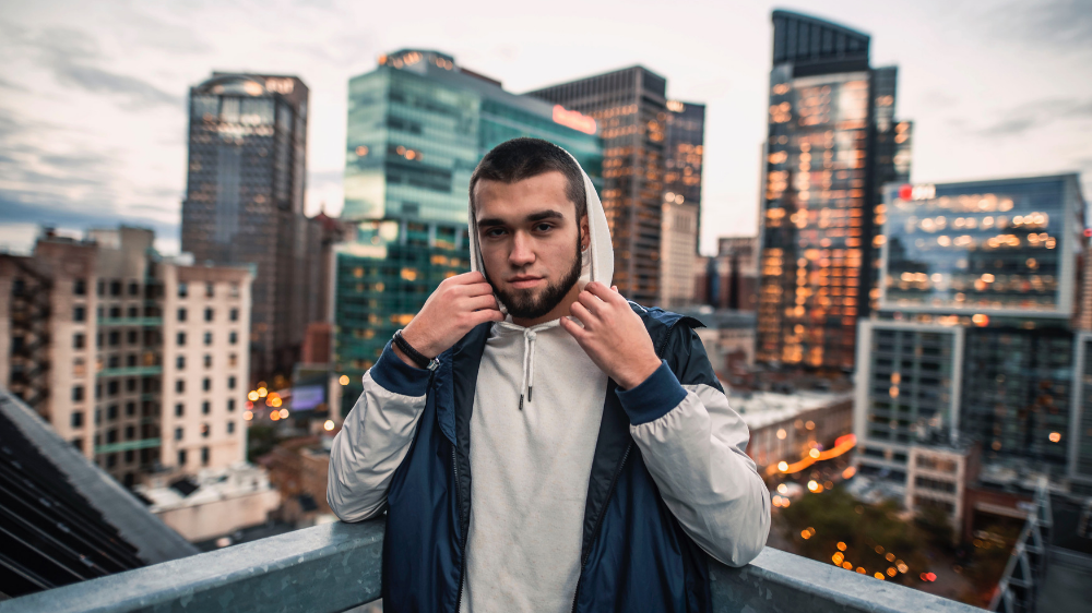 Student standing in front of city skyline