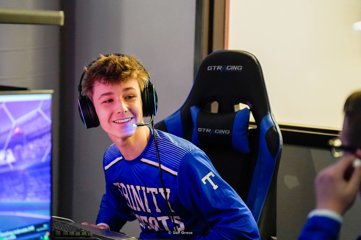 A high school esports athlete laughs.