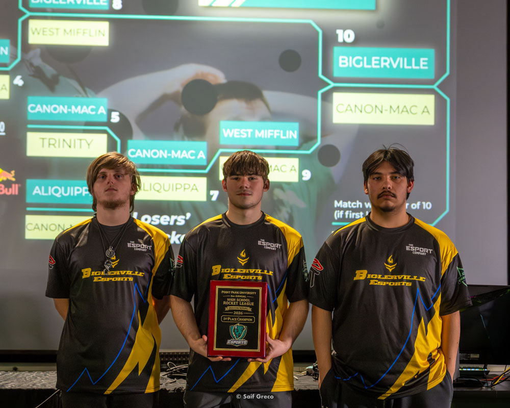Three winners of the high school esports tournament pose for a photo.