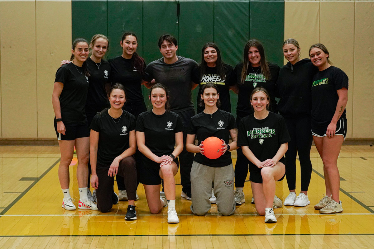 Women athletes pose for a photo in the gym.
