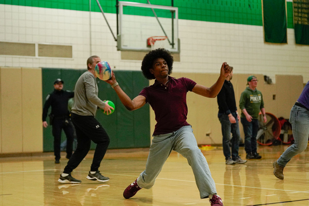 Staff members play dodgeball.