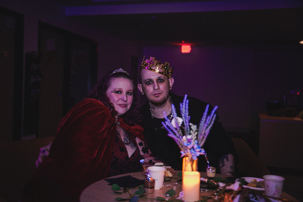 A man and woman pose for a photo at the prom.
