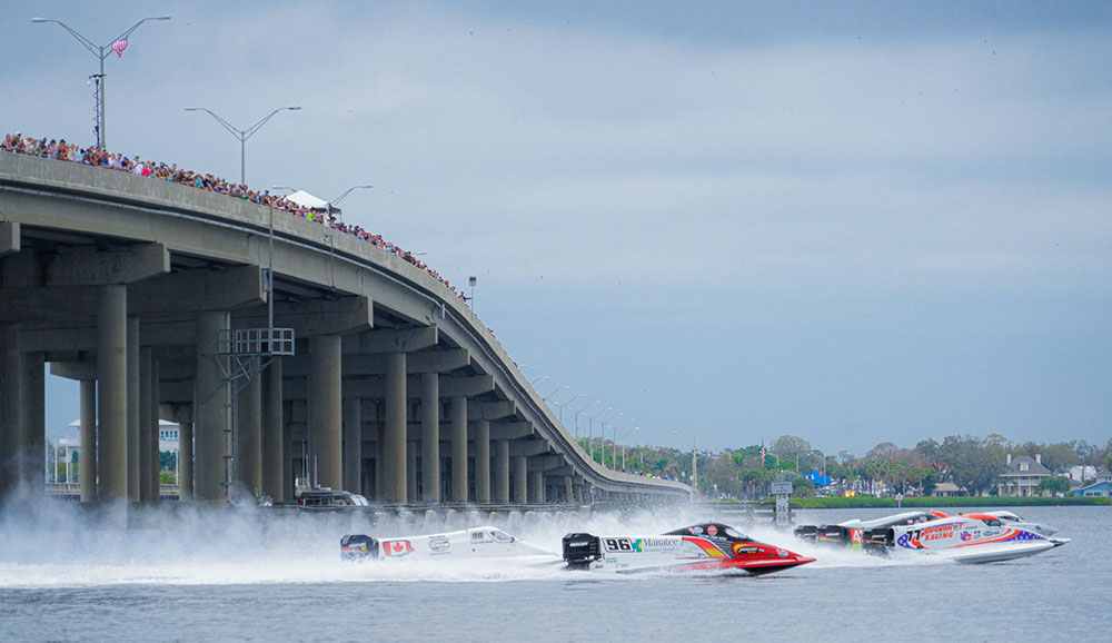 Three speedboats race.