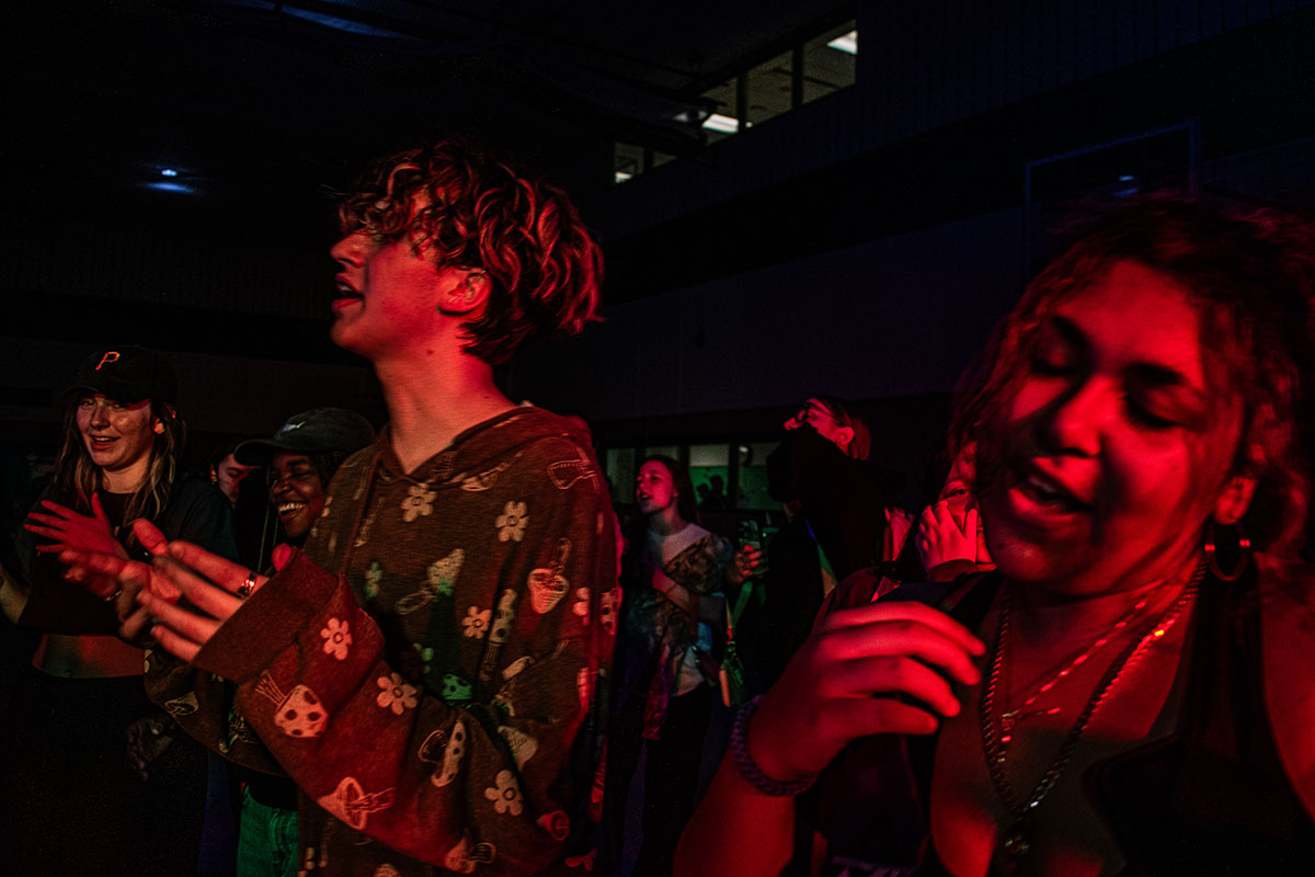 Students dance in a dark room